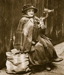 A street lady drinking tea from a typical East End beer can, near Fleet Street